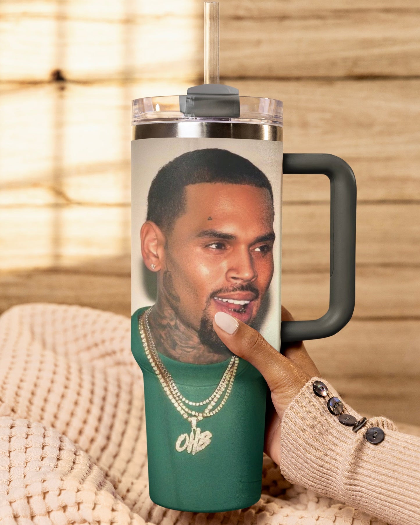 Grey 30oz Chris Brown insulated with a person holding a tumbler with a personalized design on a textured surface